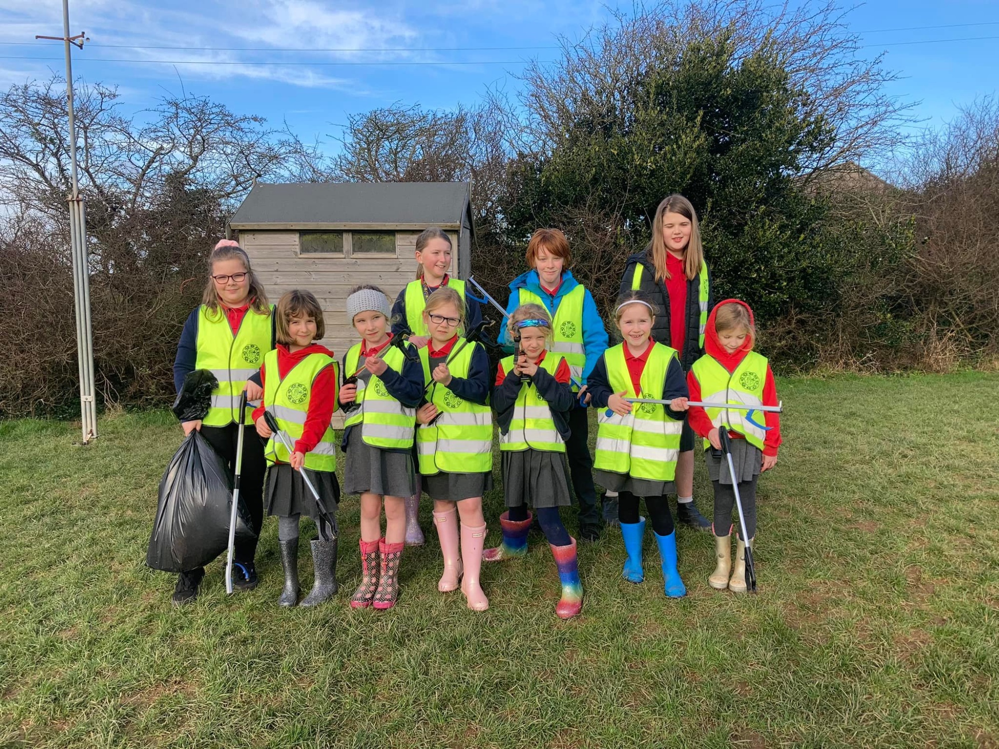 St Newlu=yn East Learning Academy children taking part in a litter pick